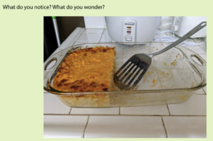 A photo of macaroni and cheese in a glass dish with a spatula and the text "What do you notice? What do you wonder?"